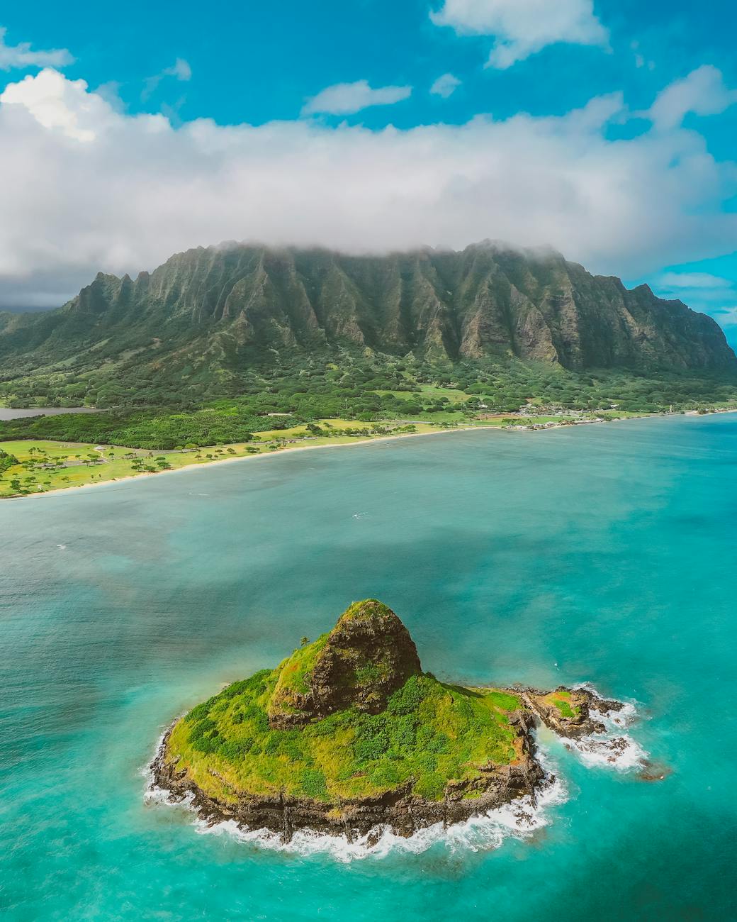 aerial photography of rocky mountains near the sea