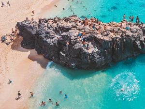 people enjoying the waimea bay