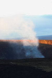 steam from crater with rocks around