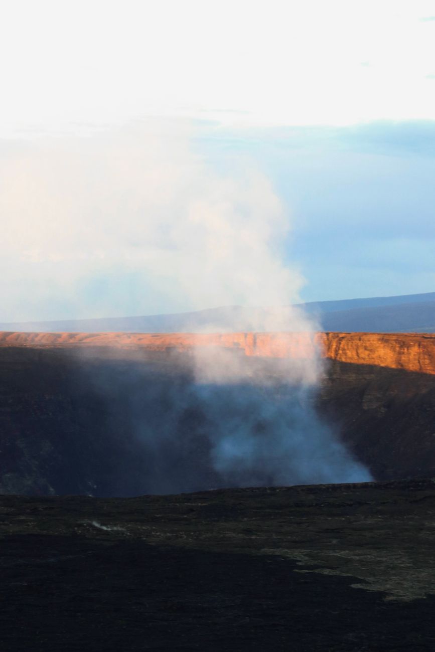 steam from crater with rocks around