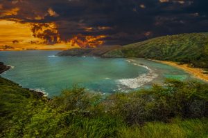 landscape photography of body of water under gray and orange sky